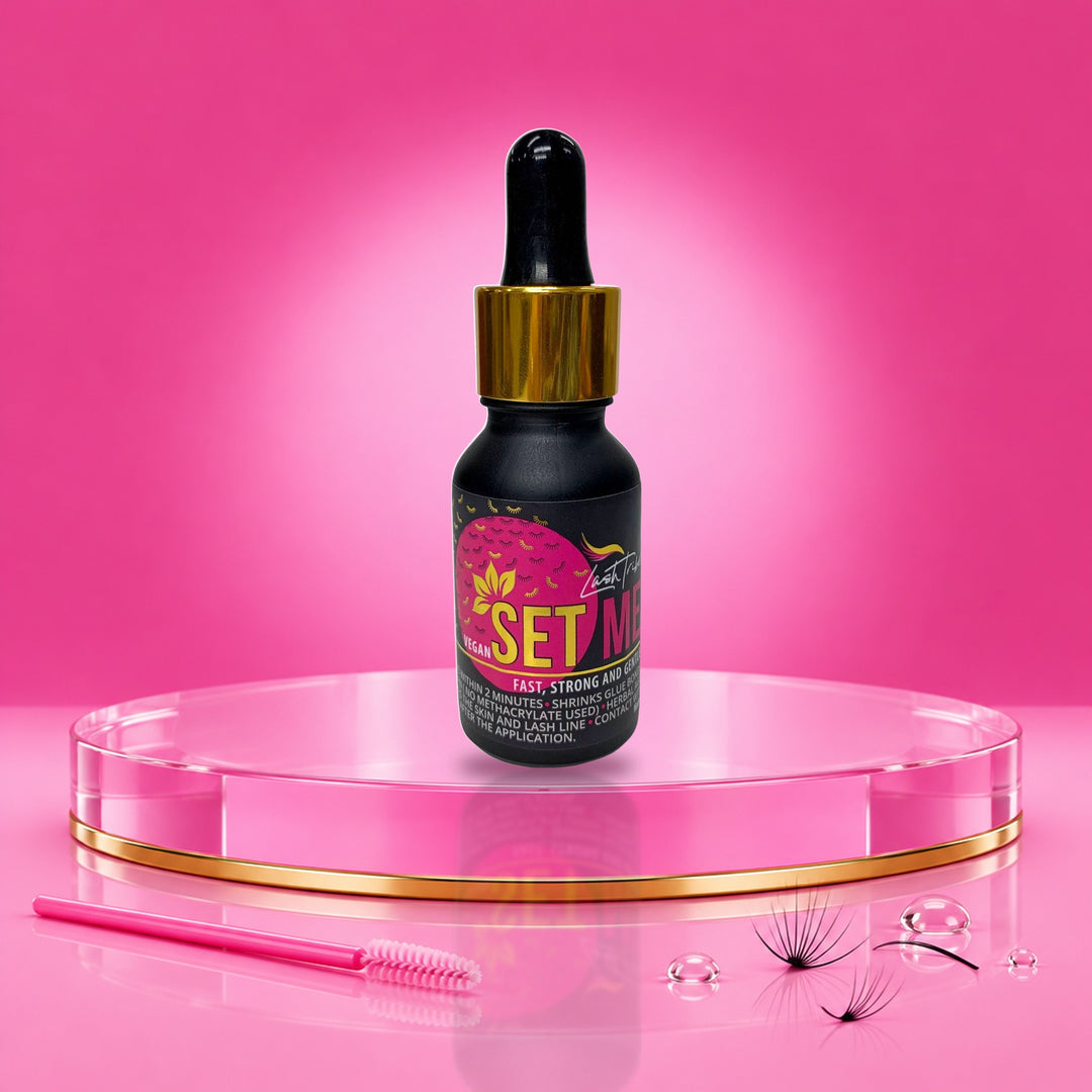 Lash Tribe Set Me vegan superbonder for eyelash extensions, 15 ml dropper bottle on a pink podium