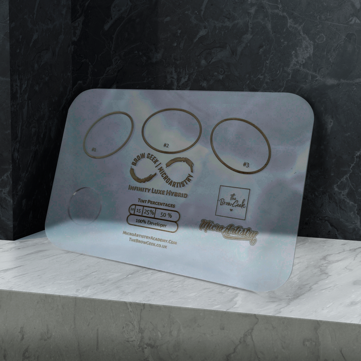A Lash Tribe INFINITY LIFT &amp; TINT PALETTE | Eyebrow and Lash Lifting sits on top of a marble counter.