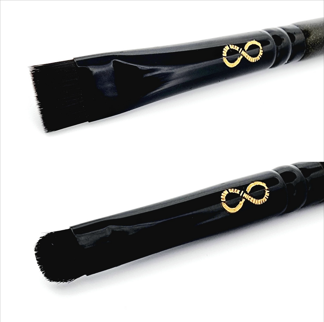 a black Infinity Buff &amp; Blend Brush with a gold handle and a black handle.