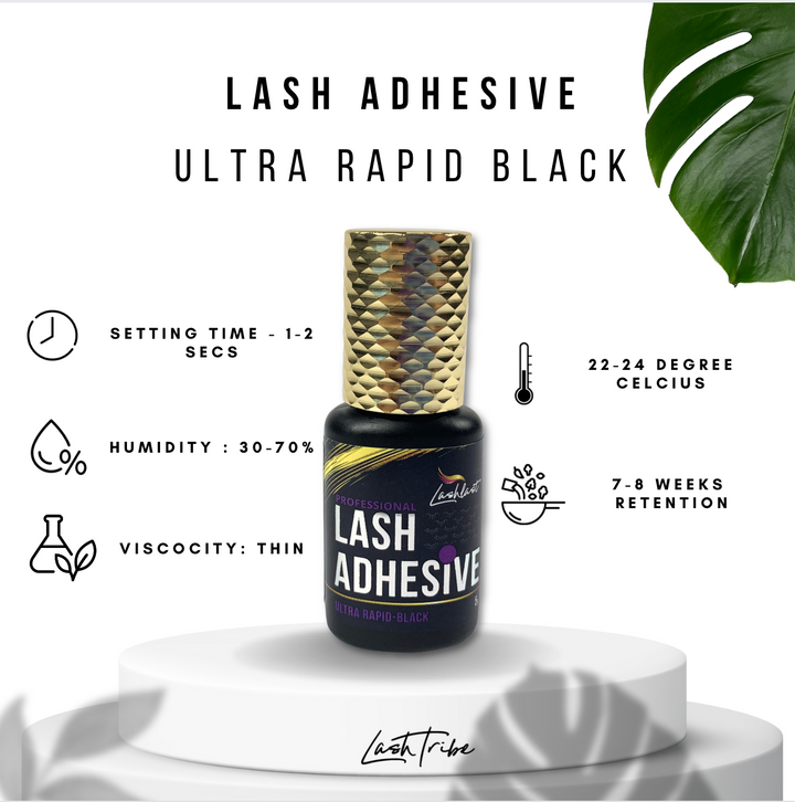 The Lash Tribe Eyelash Extensions Adhesive in sleek black, gold-capped bottle labeled “Ultra Rapid Black” sets in 1-2 seconds at 22-24°C with 30-70% humidity tolerance, and offers 7-8 weeks retention. A leaf in the background complements this product.