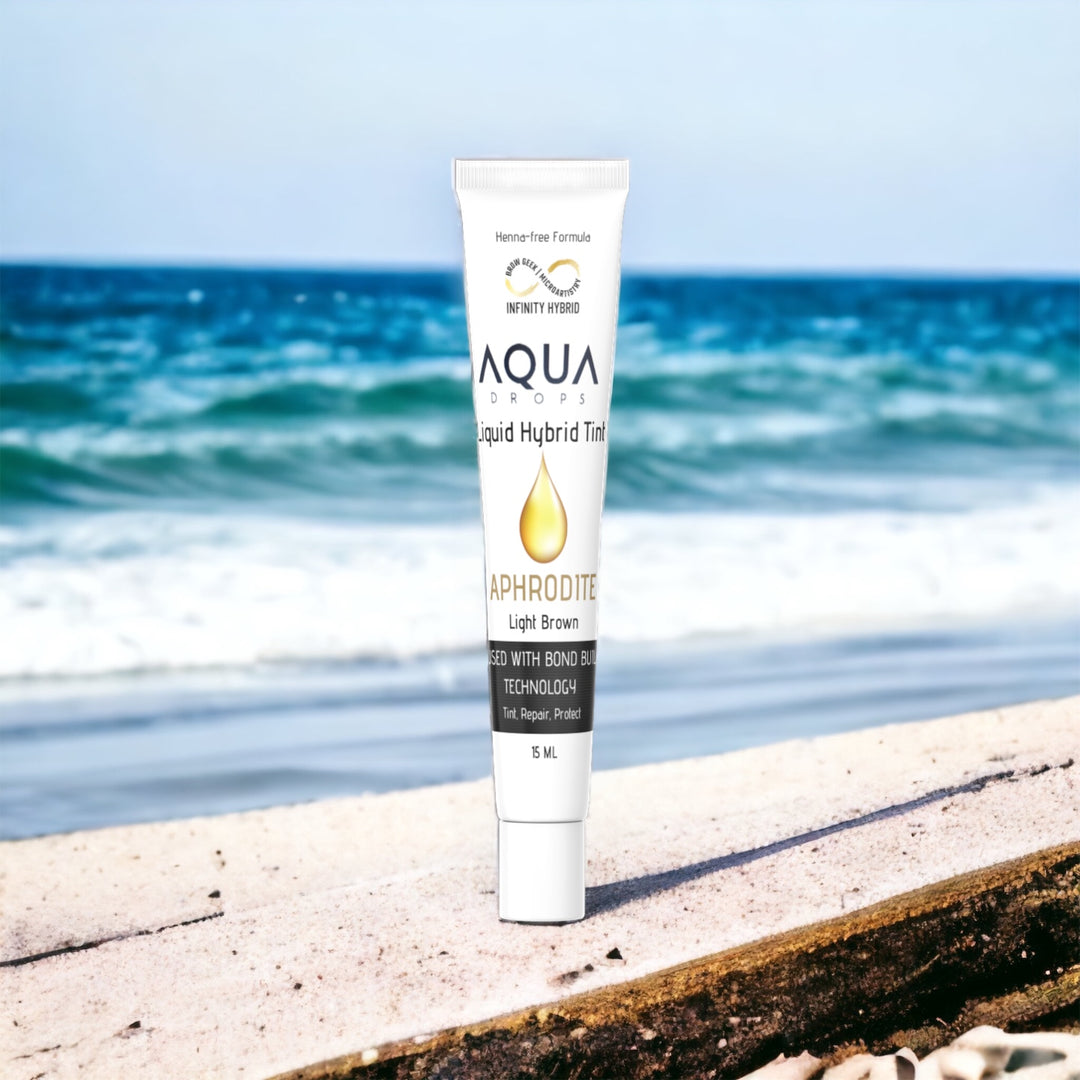 A tube of Infinity Aqua Drops sitting on a beach.