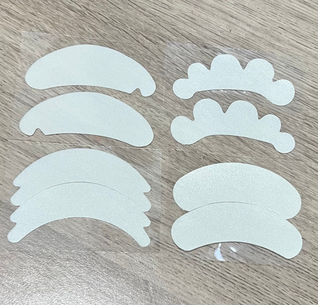 A set of Microfoam Eye Pads stickers on a wooden table.