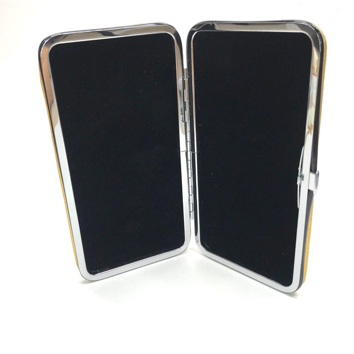 The Gold Magnetic Tweezer Case by Lash Tribe is open, revealing two black surfaces inside that securely hold 6 tweezers.