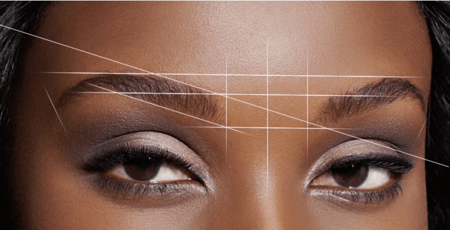 an image of a woman's eyebrows with Lash Tribe Brow Mapping String lines drawn on them.