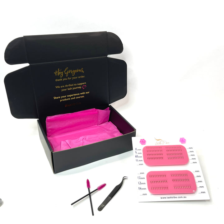 a pink box with a pair of Mega Lash Tile | Left &amp; Right Handed scissors and a pair of tweezers by Lash Tribe.