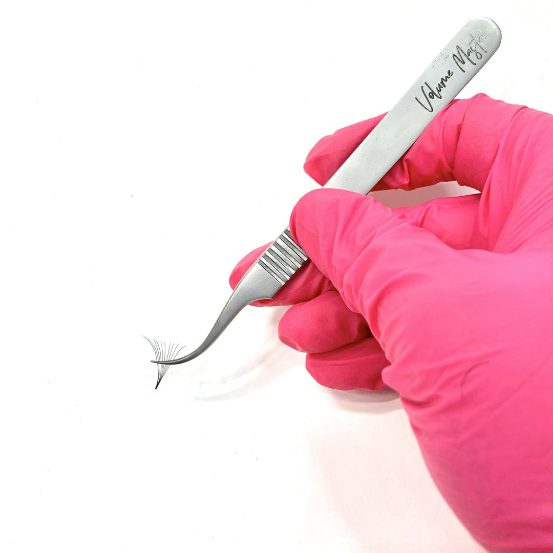 A person is holding a Lash Tribe Volume Master | Curved Precision Tweezer.