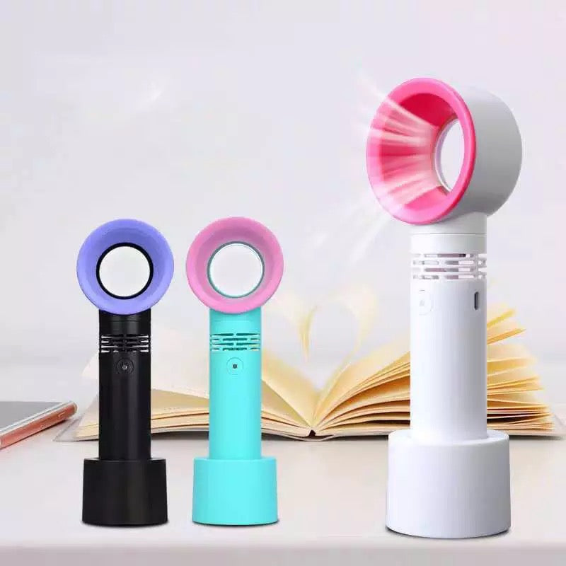 A small Lash Drying Fan for Eyelash Extensions by Lash Tribe sitting on top of a book.