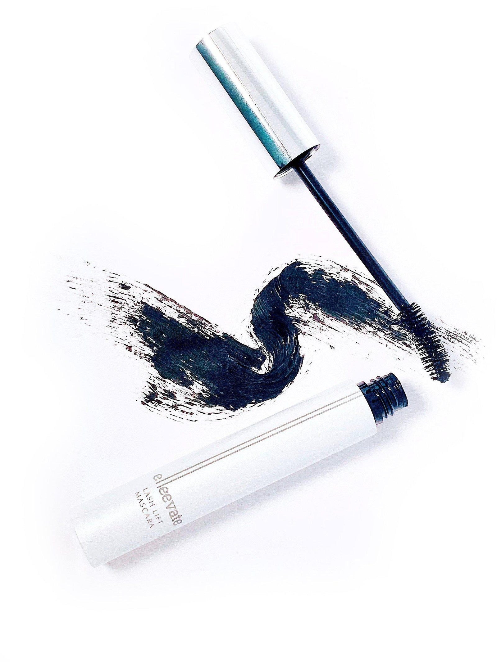 An Elleebana Elleevate Lash Lift Mascara with black smudges on a white background, perfect for salon sales and offering wholesale pricing.